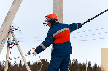 Image showing Electrician working on power lines