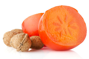 Image showing Ripe persimmons and nuts