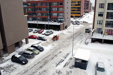 Image showing tractor clean winter snow in flat house parking 