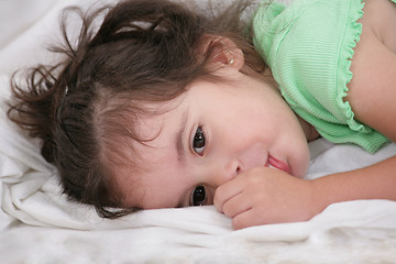 Image showing small child holding a finger in his mouth. studio photos. Close-