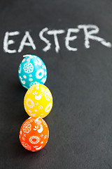 Image showing Colorful Easter egg shaped candles and text