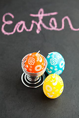 Image showing Colorful Easter egg shaped candles and text