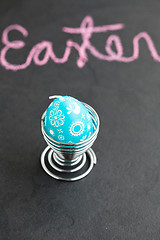 Image showing Blue easter egg shaped candle and text