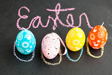 Image showing Colorful Easter egg shaped candles and text