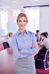 Image showing business woman with her staff in background at office