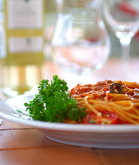 Image showing Spaghetti with a tomato sauce on a table in cafe