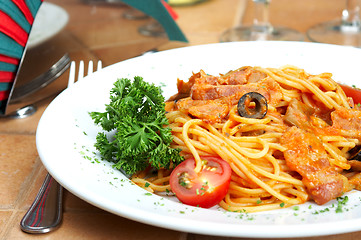 Image showing Spaghetti with a tomato sauce on a table in cafe 