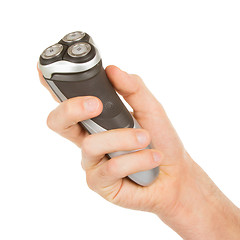 Image showing Hand holding an electric shaver 