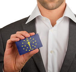 Image showing Businessman is holding a business card, Indiana