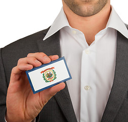 Image showing Businessman is holding a business card, West Virginia