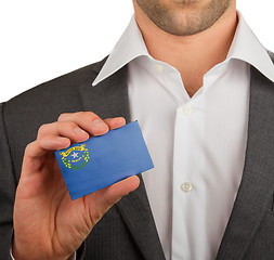 Image showing Businessman is holding a business card, Nevada