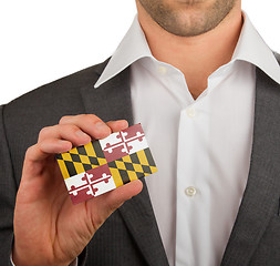 Image showing Businessman is holding a business card, Maryland