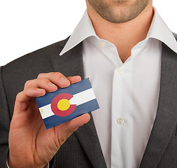 Image showing Businessman is holding a business card, Colorado