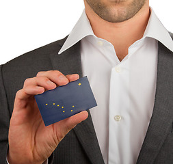 Image showing Businessman is holding a business card, Alaska