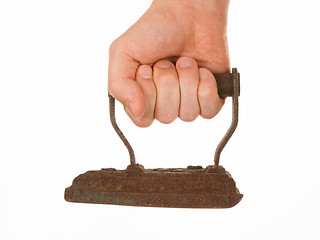 Image showing Hand holding an old iron, isolated