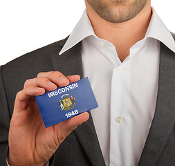 Image showing Businessman is holding a business card, Wisconsin