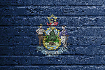 Image showing Brick wall with a painting of a flag, Maine