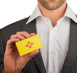 Image showing Businessman is holding a business card, New Mexico