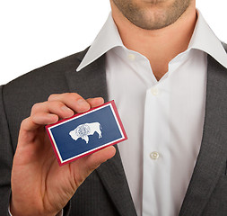 Image showing Businessman is holding a business card, Wyoming