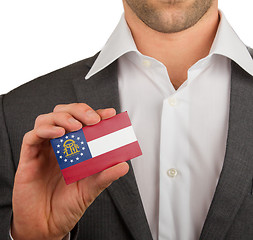 Image showing Businessman is holding a business card, Georgia