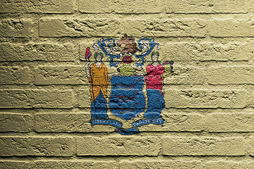 Image showing Brick wall with a painting of a flag, New Jersey