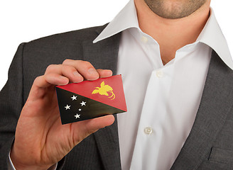 Image showing Businessman is holding a business card, Papua New Guinea