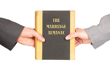 Image showing Man and woman holding a marriage almanac