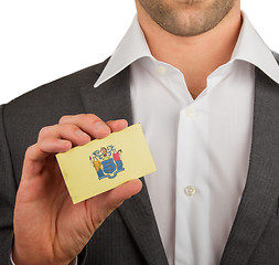 Image showing Businessman is holding a business card, New Jersey