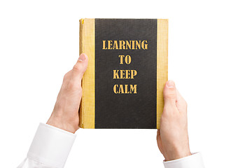 Image showing Businessman holding an old book