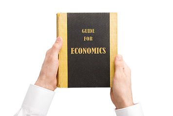 Image showing Businessman holding an old book