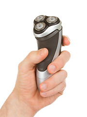 Image showing Hand holding an electric shaver 