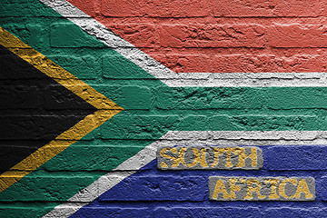 Image showing Brick wall with a painting of a flag