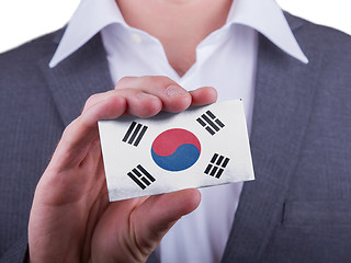 Image showing Businessman showing card, matte paper effect