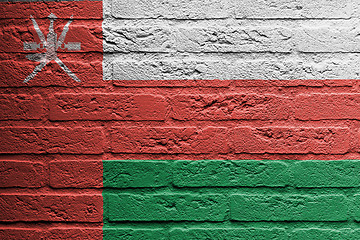 Image showing Brick wall with a painting of a flag, Oman