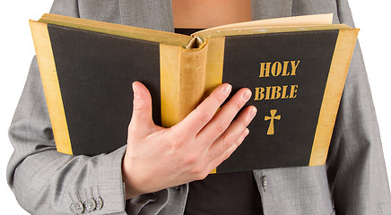 Image showing Woman in business suit is reading a holy bible