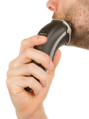 Image showing Young man shaving his beard off