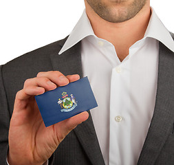 Image showing Businessman is holding a business card, Maine