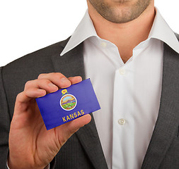 Image showing Businessman is holding a business card, Kansas
