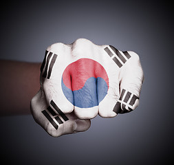 Image showing Front view of punching fist on gray background