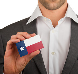 Image showing Businessman is holding a business card, Texas