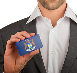 Image showing Businessman is holding a business card, Michigan