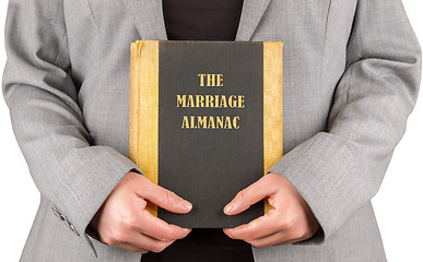 Image showing Woman holding a marriage almanac