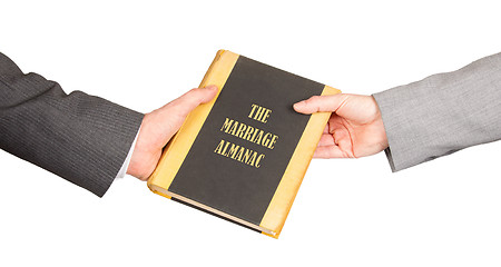 Image showing Man and woman holding a marriage almanac