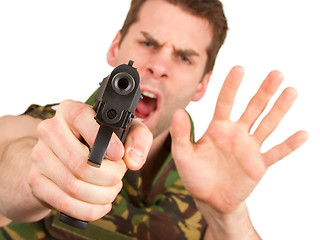 Image showing Soldier in camouflage vest is holding a gun