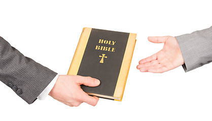 Image showing Man and woman in business suits are holding a holy bible