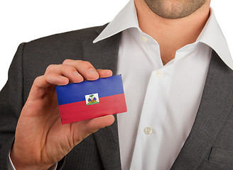 Image showing Businessman is holding a business card, Haiti