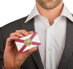 Image showing Businessman is holding a business card, Florida