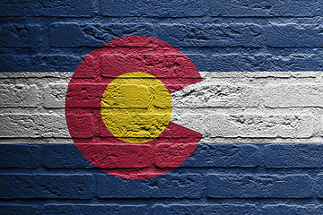 Image showing Brick wall with a painting of a flag, Colorado