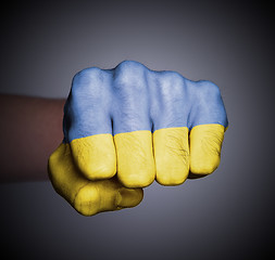 Image showing Front view of punching fist on gray background