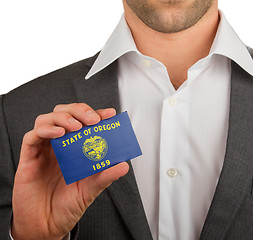 Image showing Businessman is holding a business card, Oregon